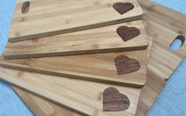 Several Bounceback Food CIC chopping boards displayed on top of each other