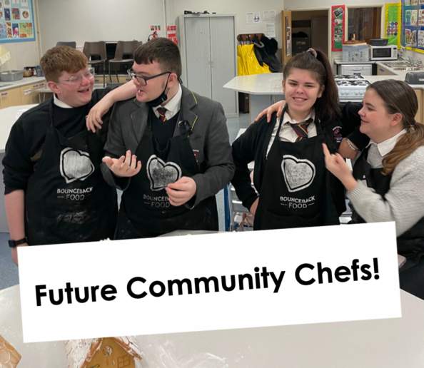 A group of young people in a cookery classroom taking part in a Bounceback Food CIC cookery workshop.